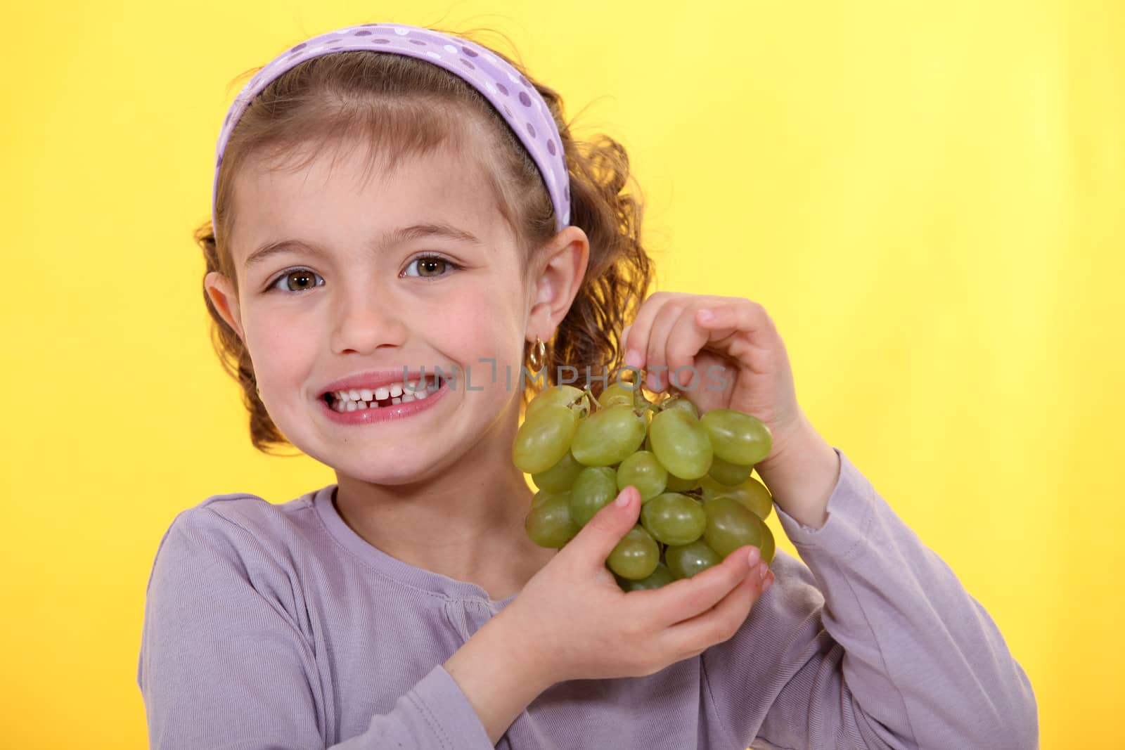 Girl with bunch of grapes by phovoir