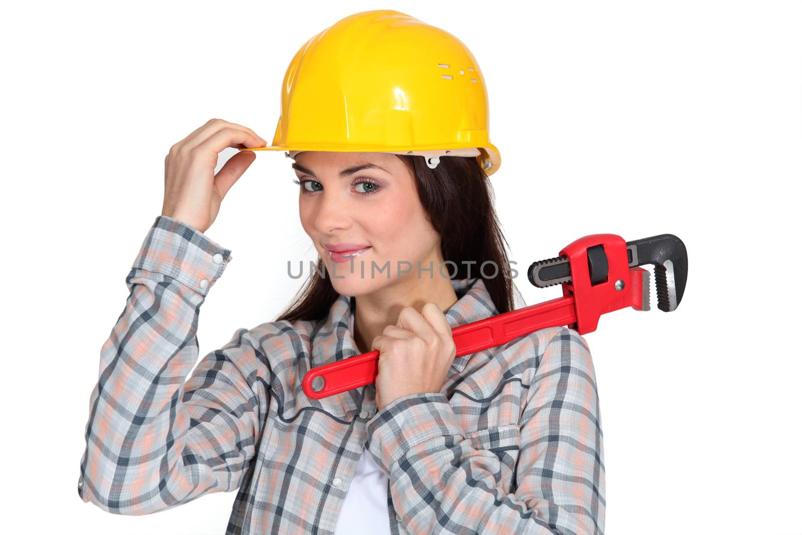 Tradeswoman holding a pipe wrench by phovoir