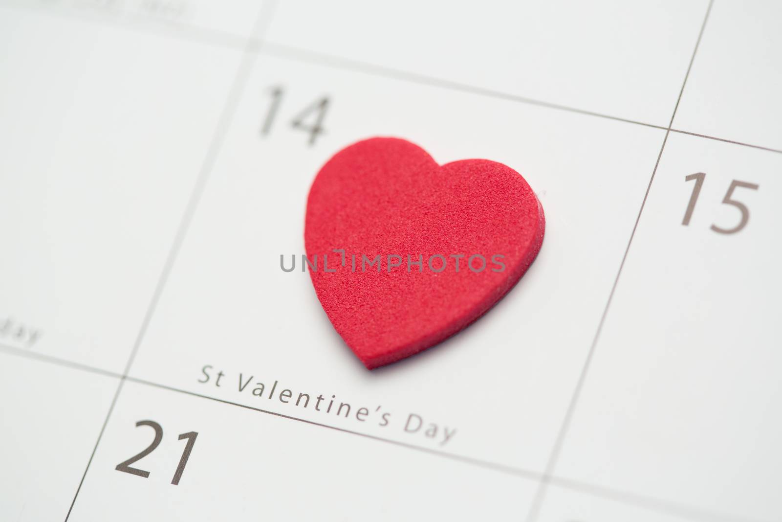 Close up of pink heart on valentines day on white calendar