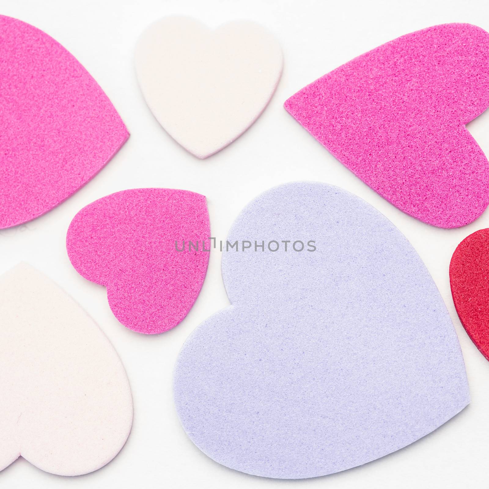 Various confetti hearts on white background