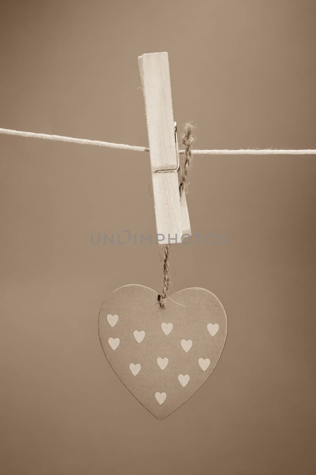 Heart ornament hanging from a peg on a line by Wavebreakmedia