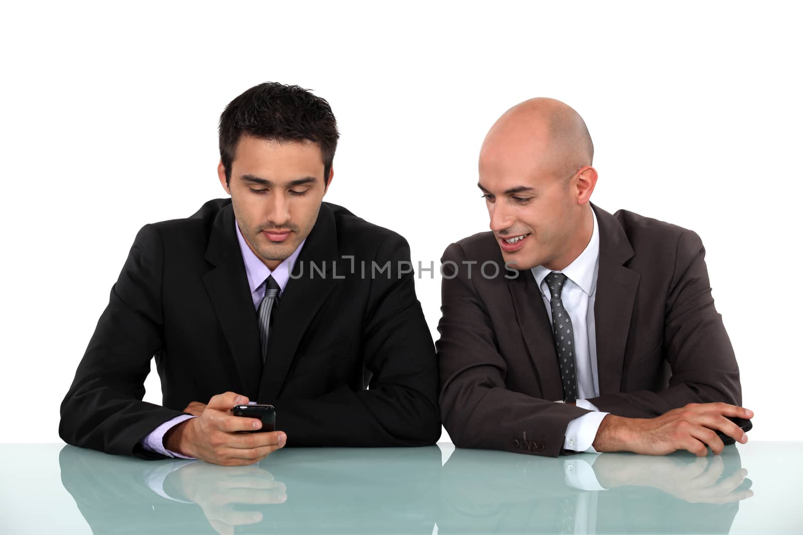 two businessman having a pleasant conversation by phovoir