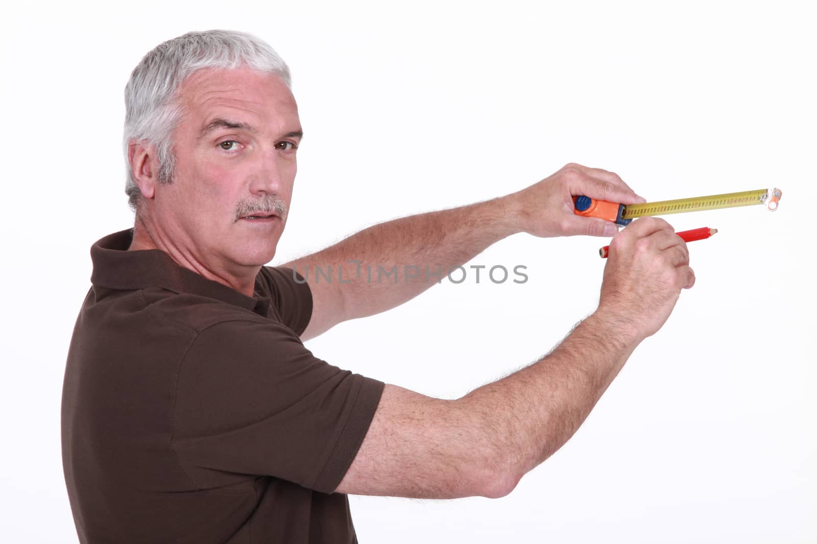 Man using a measuring tape by phovoir