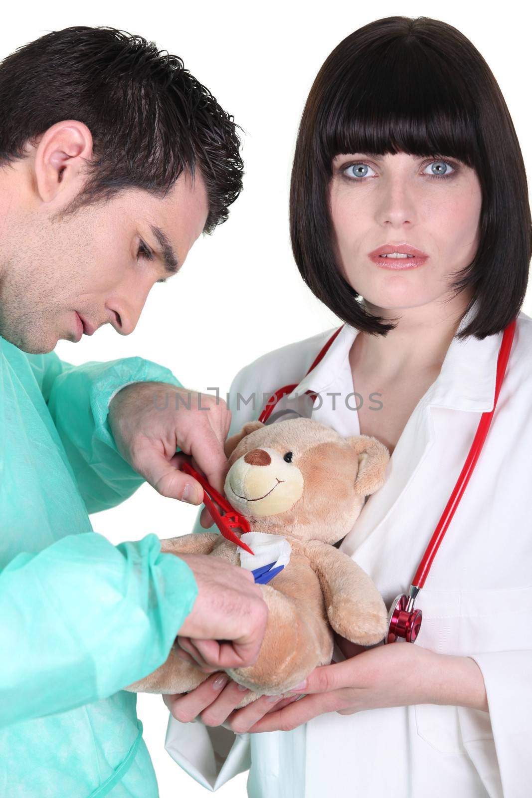 Surgeon with assistant operating teddy bear by phovoir