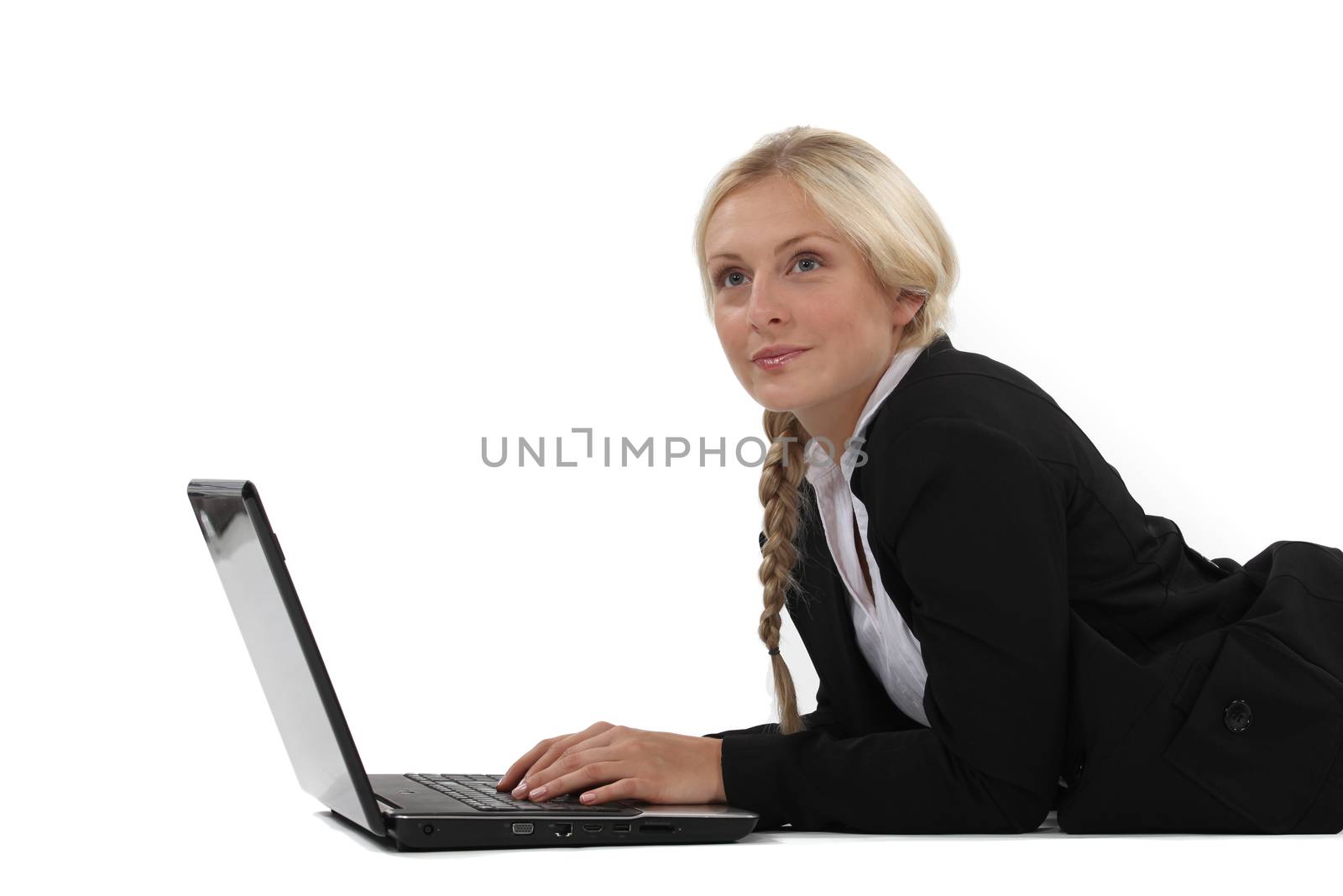 Dreamy woman typing on her laptop by phovoir