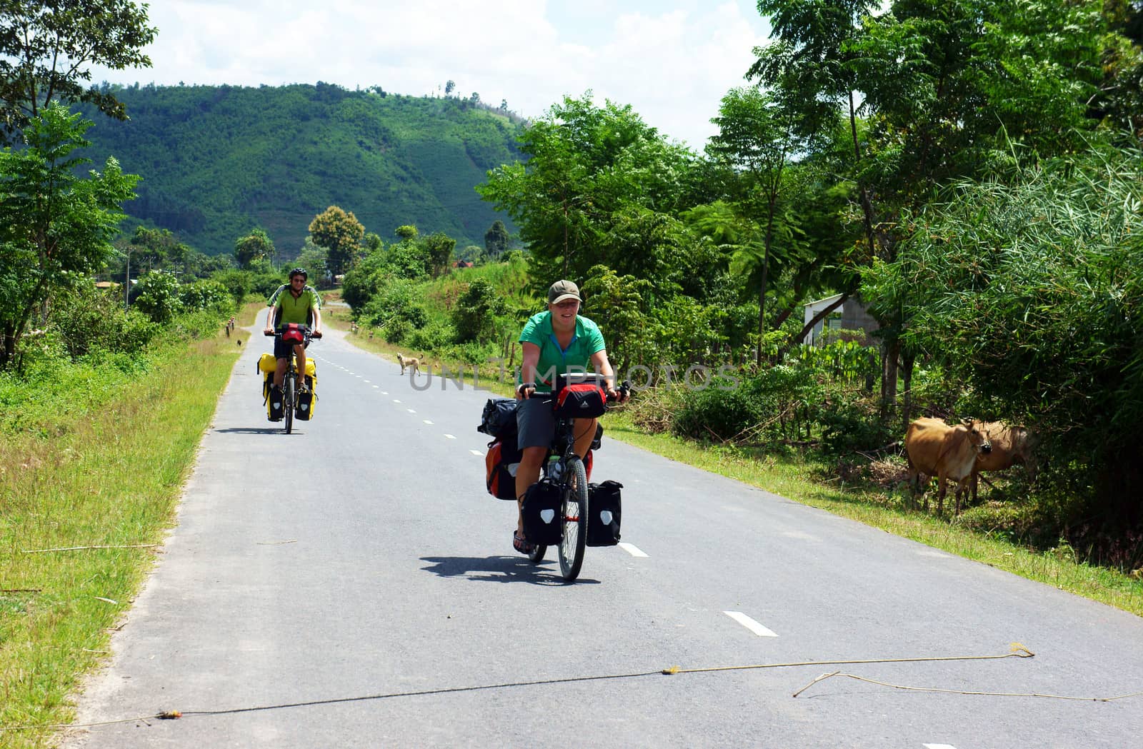 Traveller ride bicycle on the road conect Dalat to Daklak, this is the nice road with fresh air, neglected landcape. Viet Nam- September 3, 2013