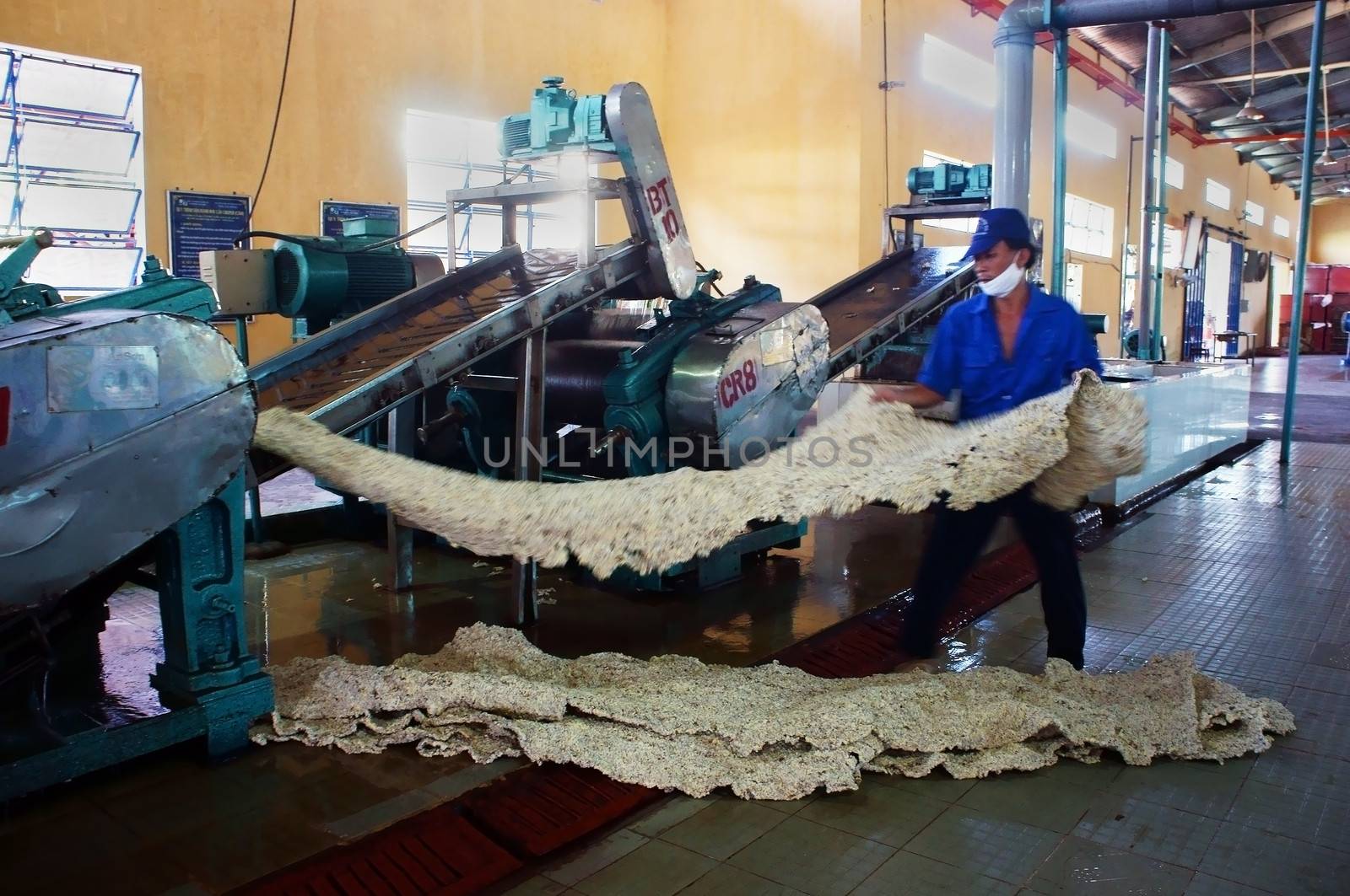in Viet Nam, there are many rubber plantation, rubber latex after collected, transport to factory.Right here, prelimitary treatment processing in ten stage, this is the fifth to make sheet.Binh Phuoc, Viet Nam- May 9, 2013.