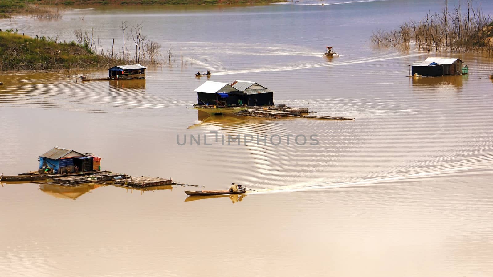  the scene of fisherman coming their lake dwelling by motor-boat at fishing village create ripplings on the water suface is so lively. This fishing village locate at NamKa lake, Dalak.