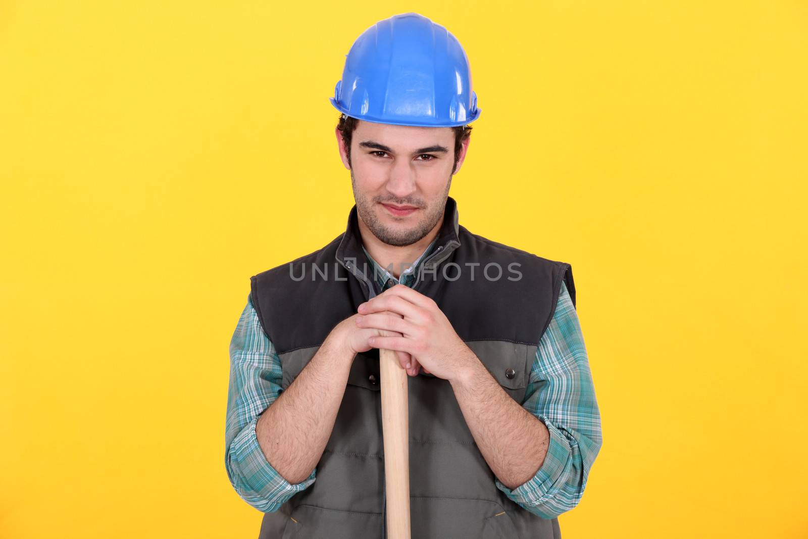 Manual worker stood with large hammer by phovoir