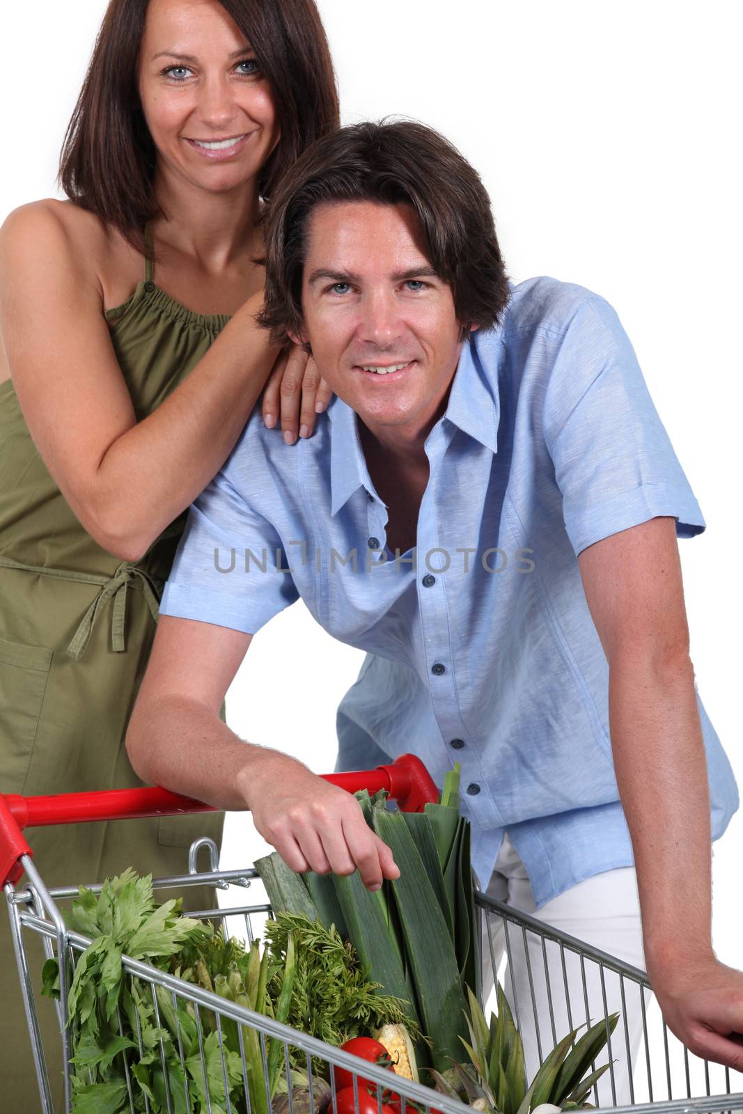 Couple with trolley full of vegetables