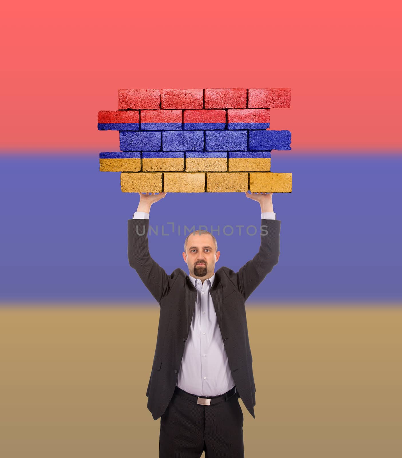 Businessman holding a large piece of a brick wall, flag of Armenia, isolated on national flag