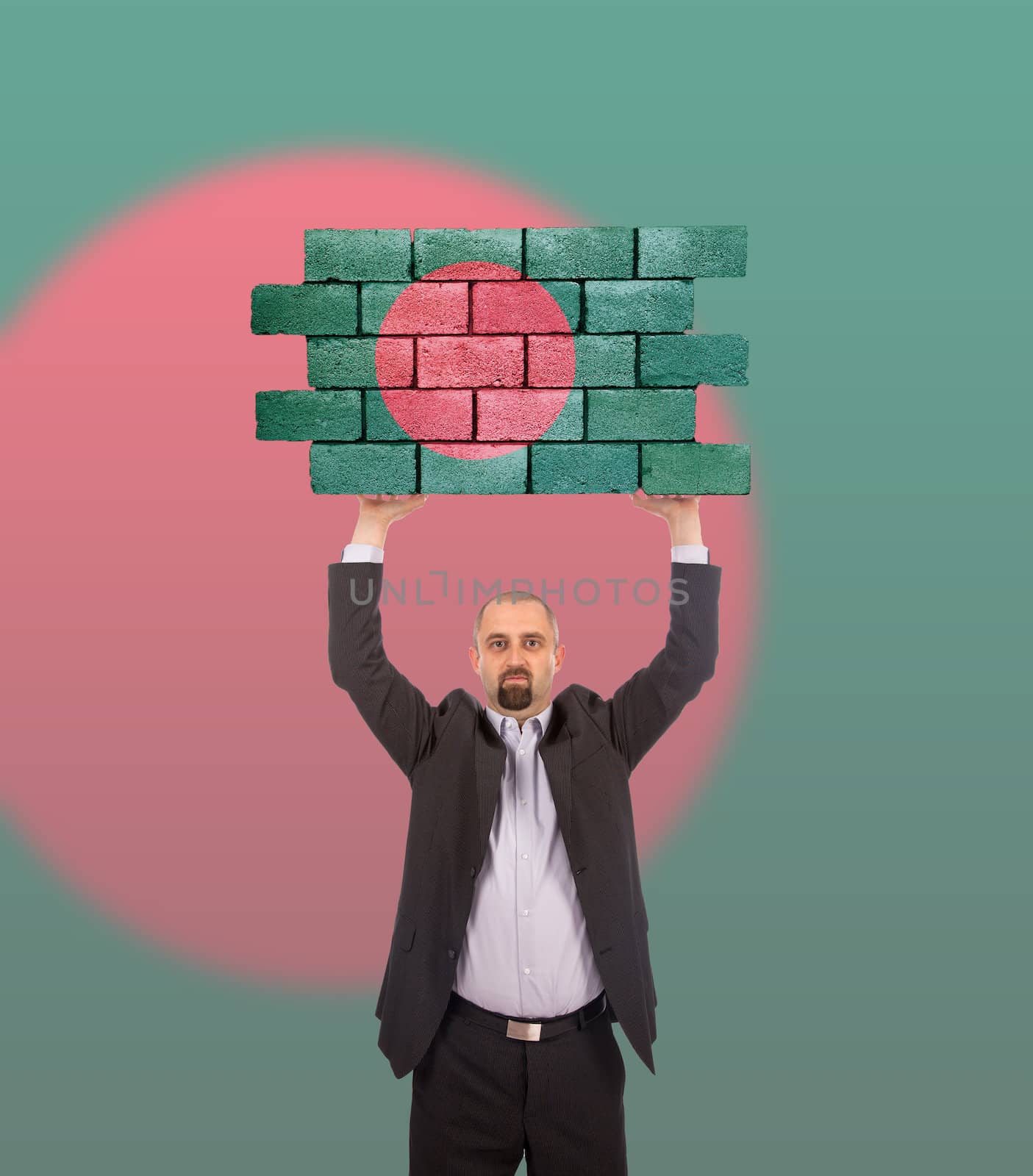 Businessman holding a large piece of a brick wall, flag of Bangladesh, isolated on national flag