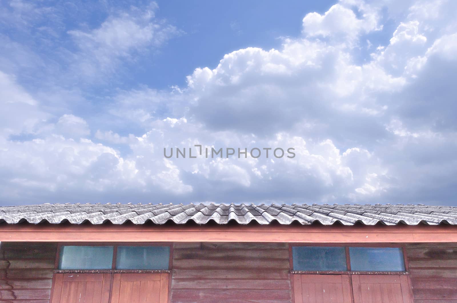 The Bright Cloudy Blue Sky over Roof of House