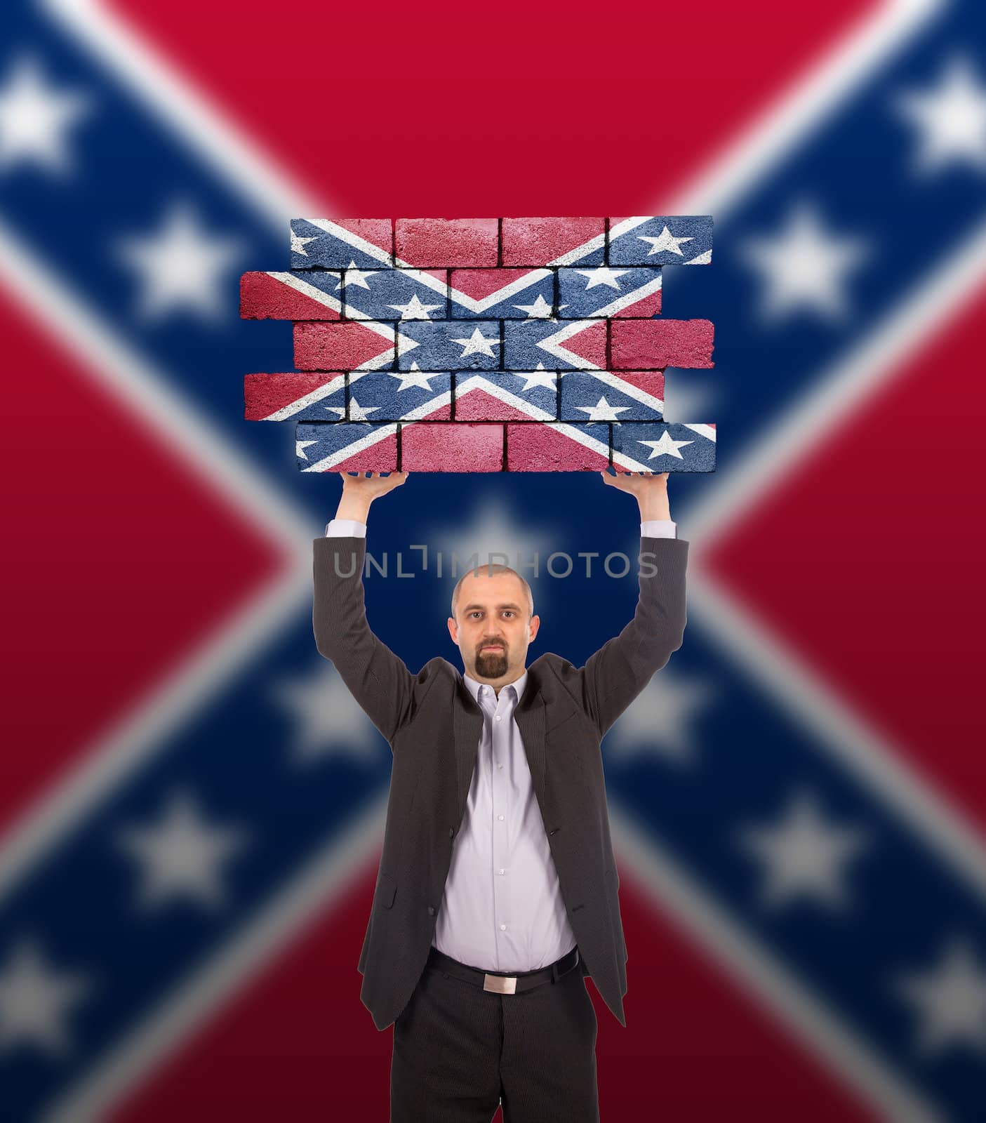 Businessman holding a large piece of a brick wall, Confederate flag, isolated