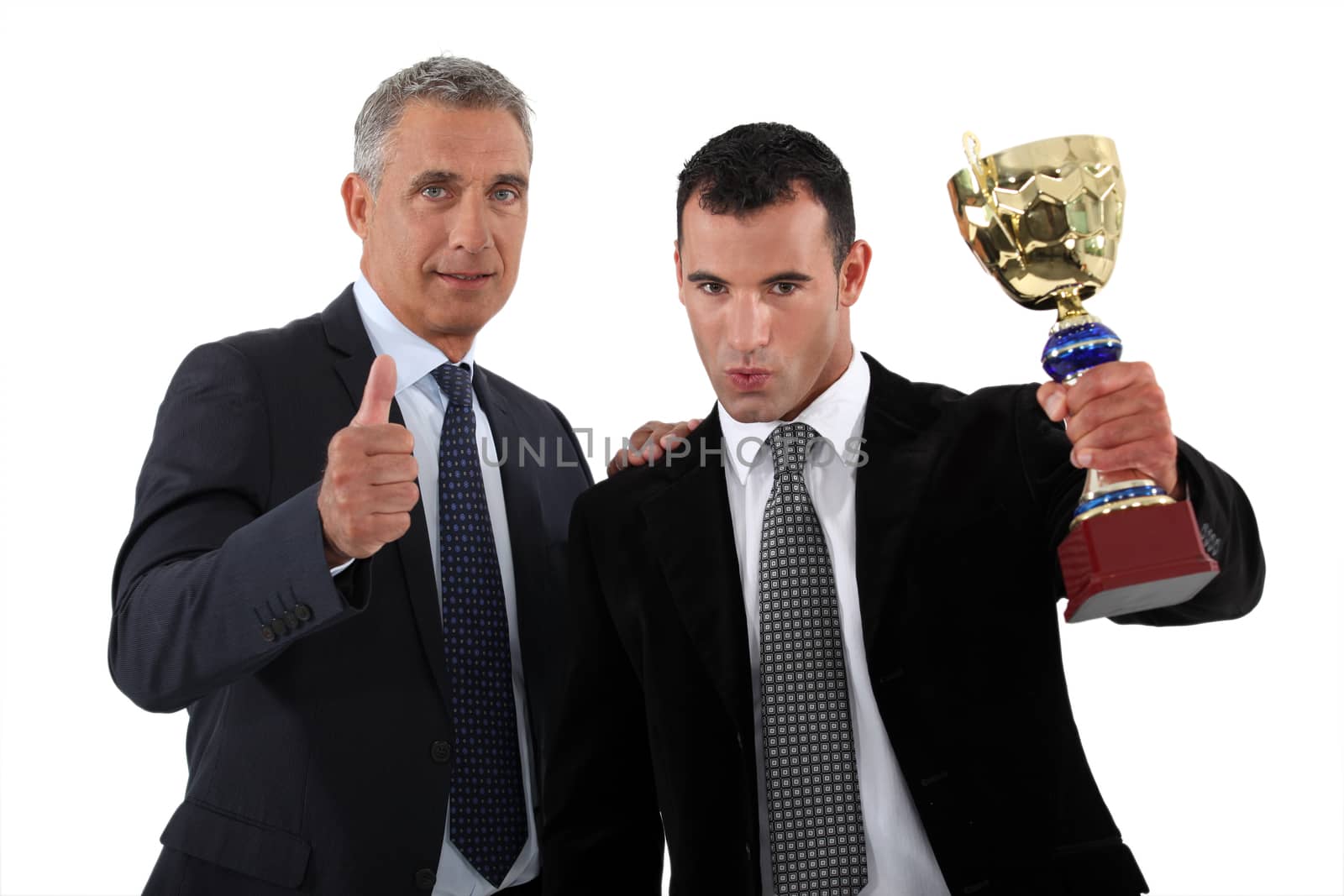 Businessmen with a trophy by phovoir