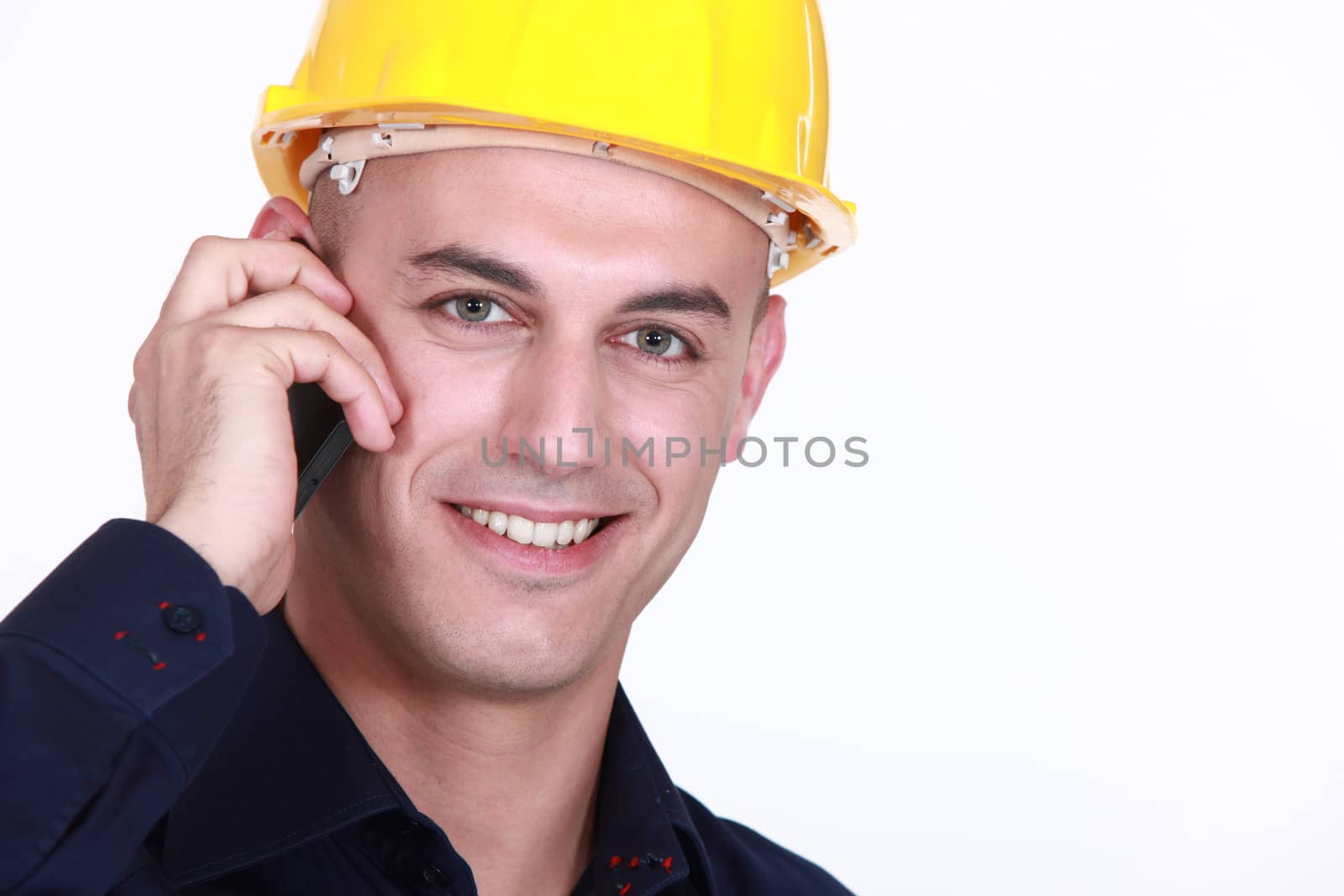Worker with a cellphone by phovoir