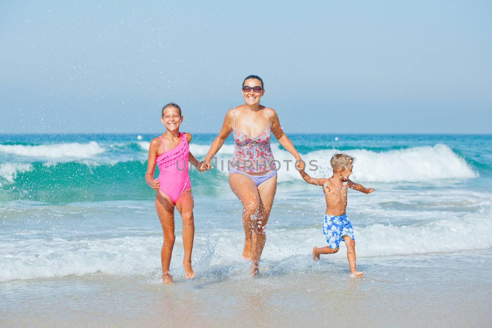 Kids and mother on the beach by maxoliki
