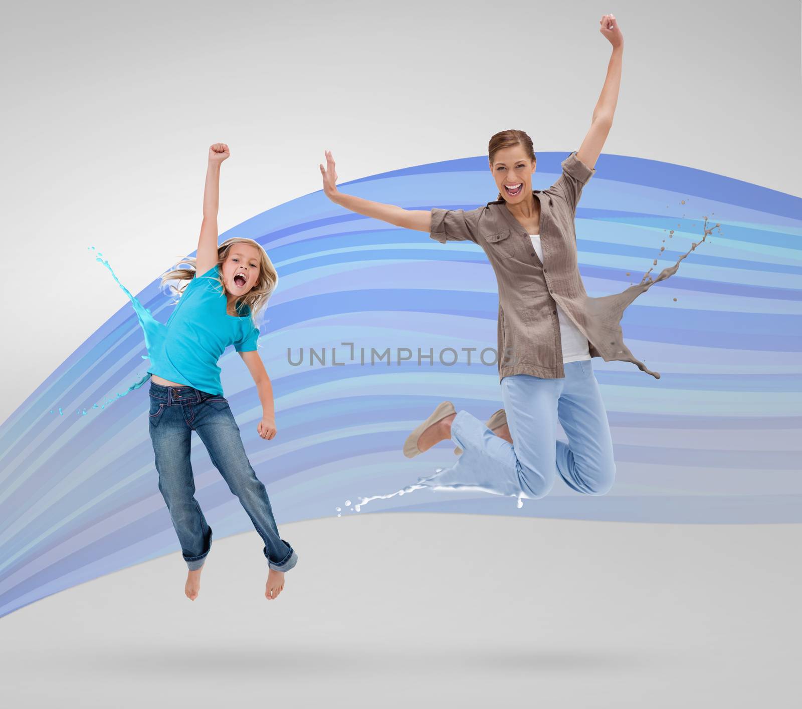 Woman and daughter jumping with clothes turning to paint splatters by Wavebreakmedia