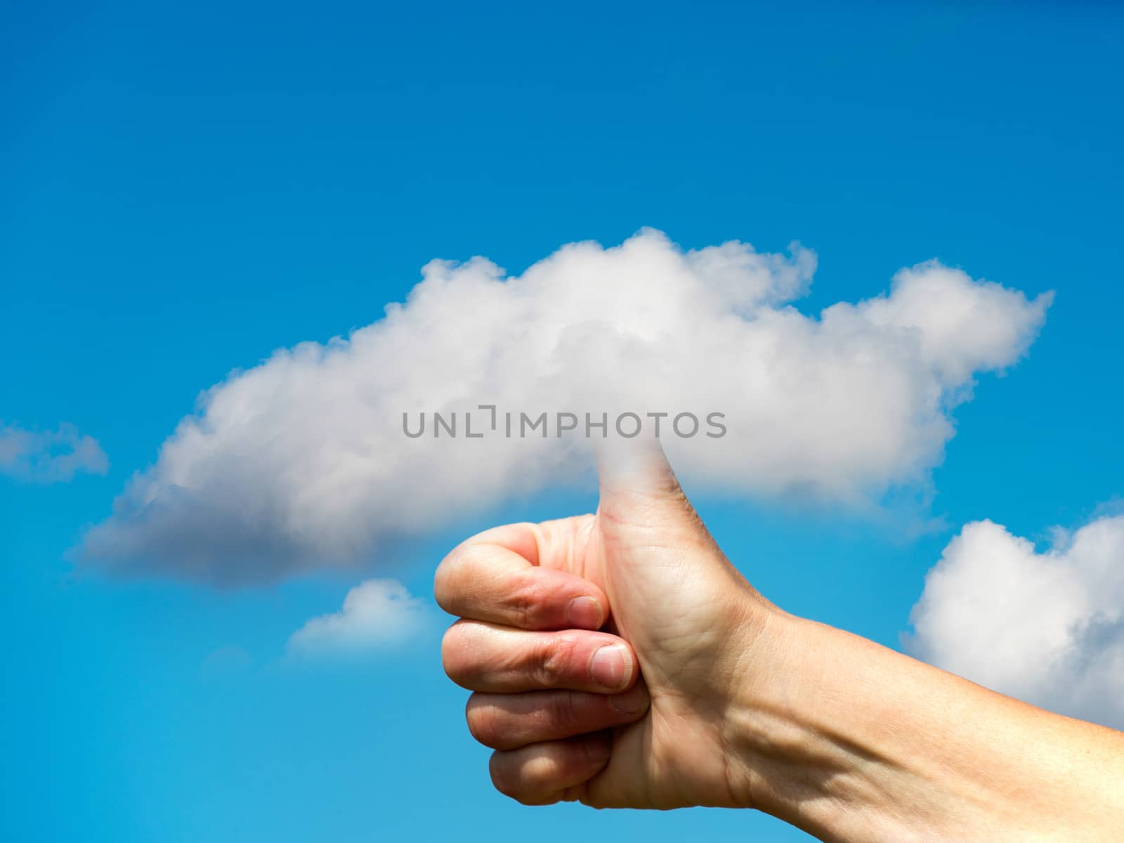 hand with thumb in the clouds with blue sky