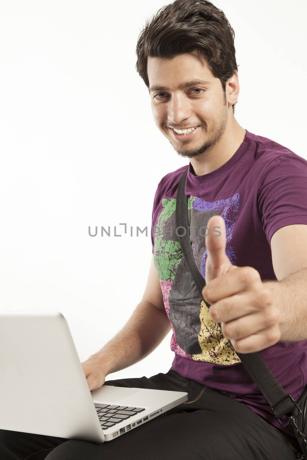 young male working on laptop thumbs up by haiderazim