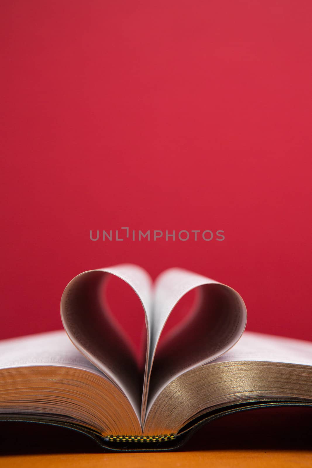 Embossed pages of book folded to make heart by Wavebreakmedia