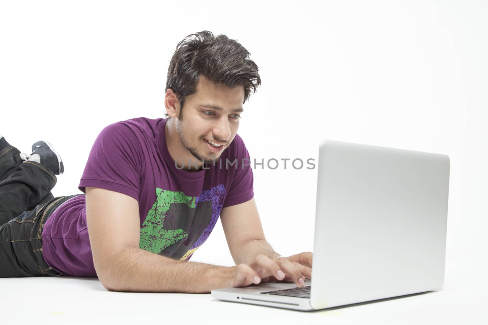 Young male relaxed working on laptop
