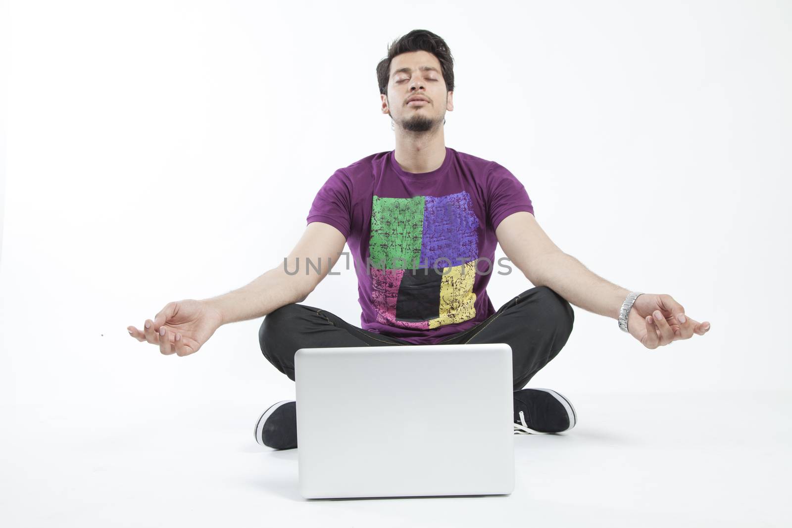 Man meditating infront of a laptop by haiderazim
