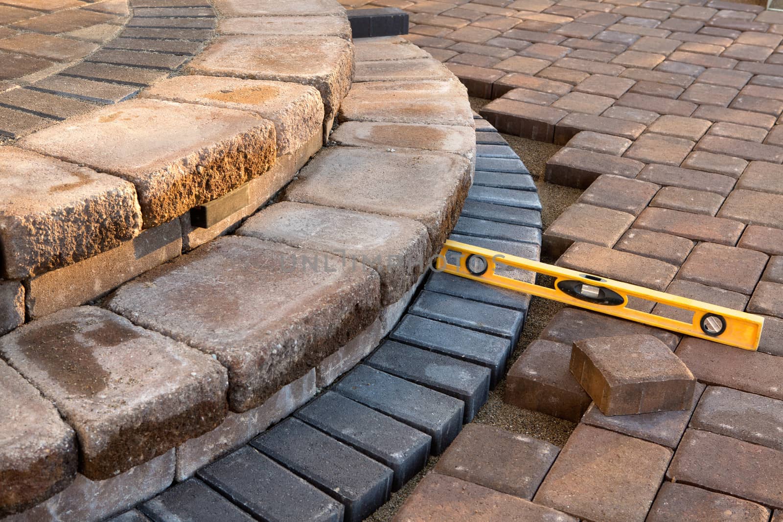 Pavers meets with patio steps and job completion almost done, last check with yellow level