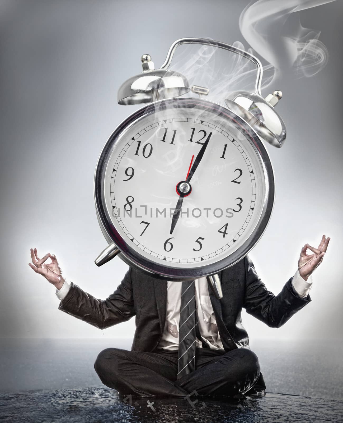 Businessman meditating with face covered by giant smoking alarm clock