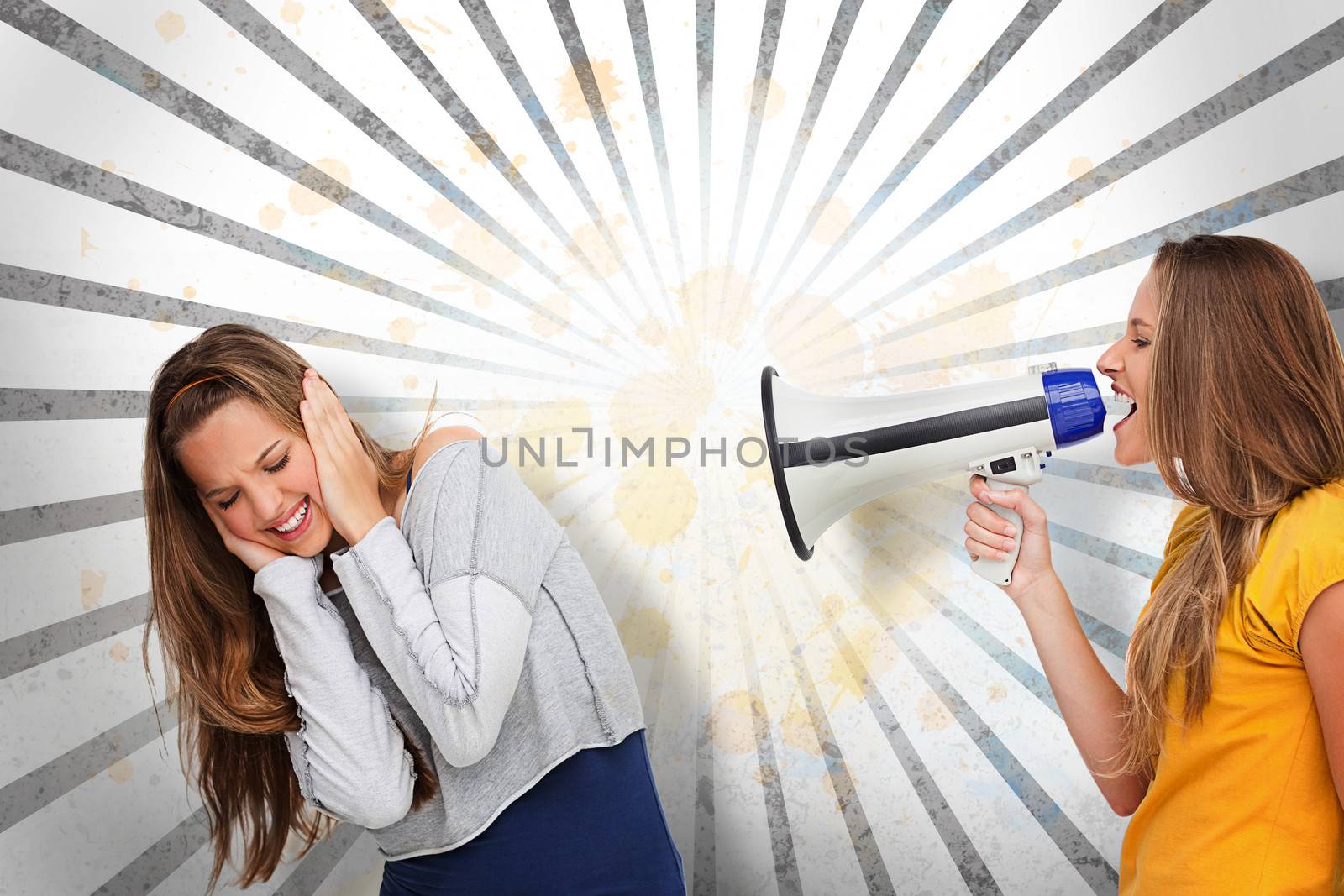 Girl shouting at her friend through megaphone on grey and white linear pattern
