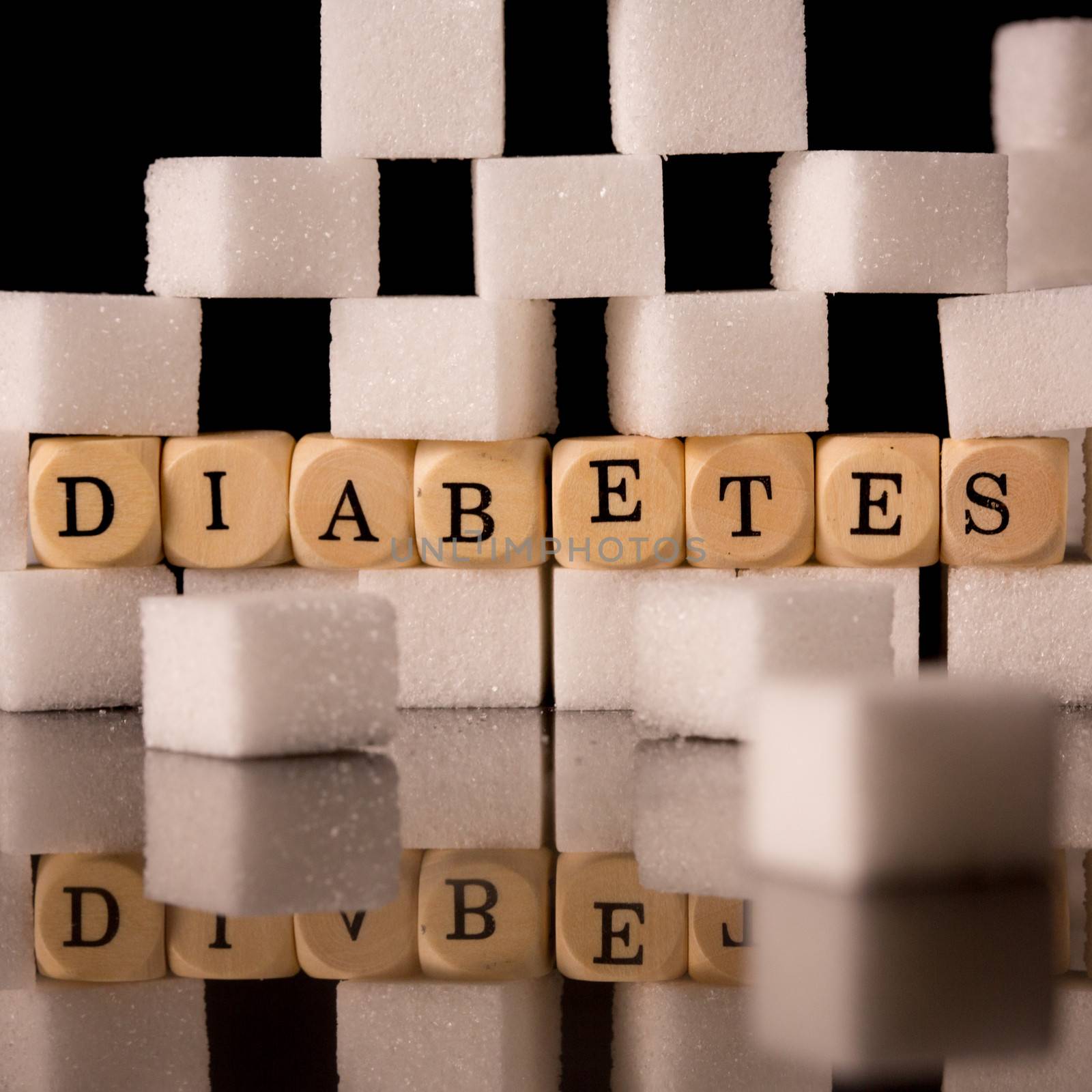 Close up on sugar cubes and dice spelling diabetes by Wavebreakmedia