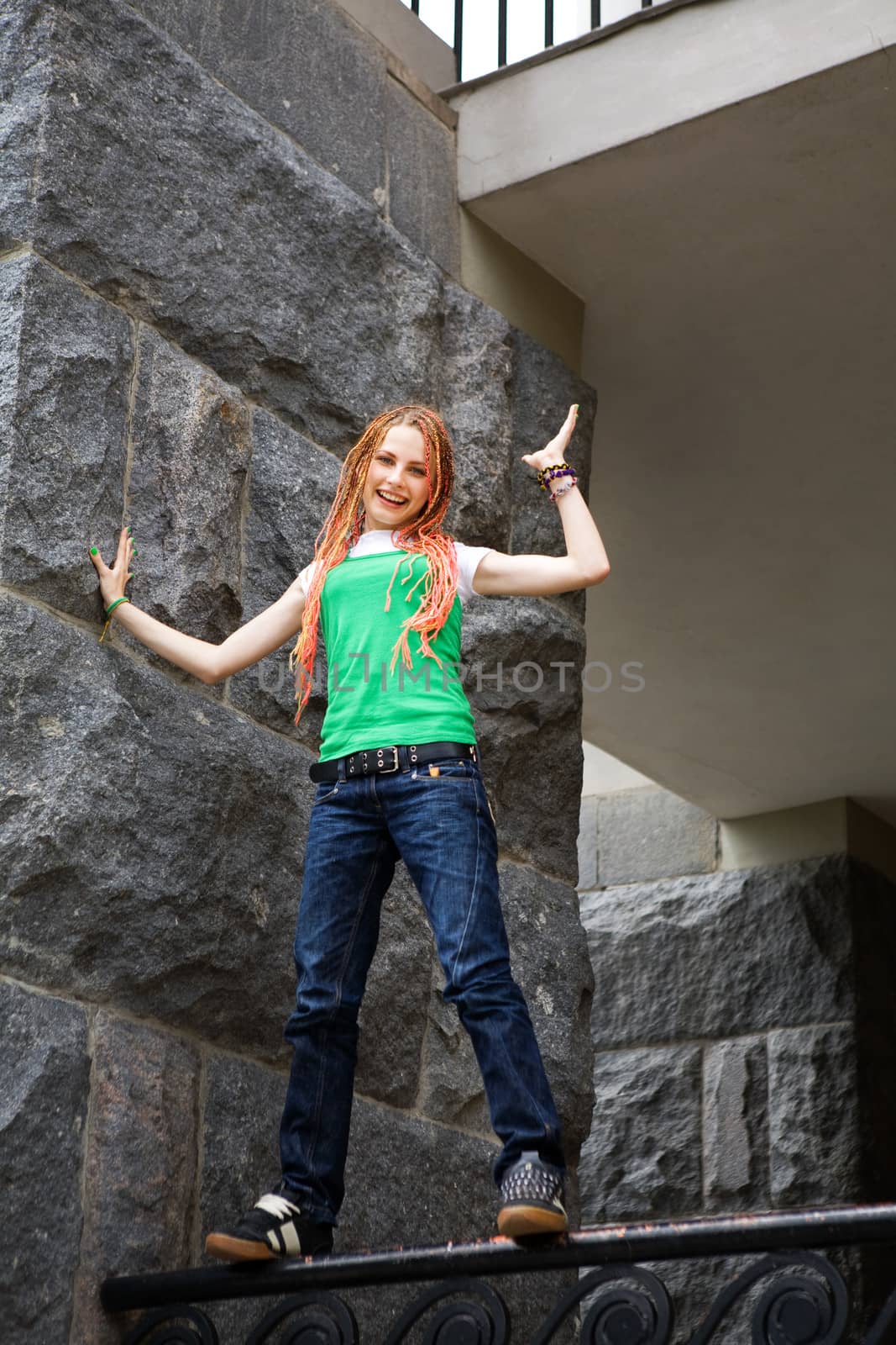 teenage girl on the fencing of the city