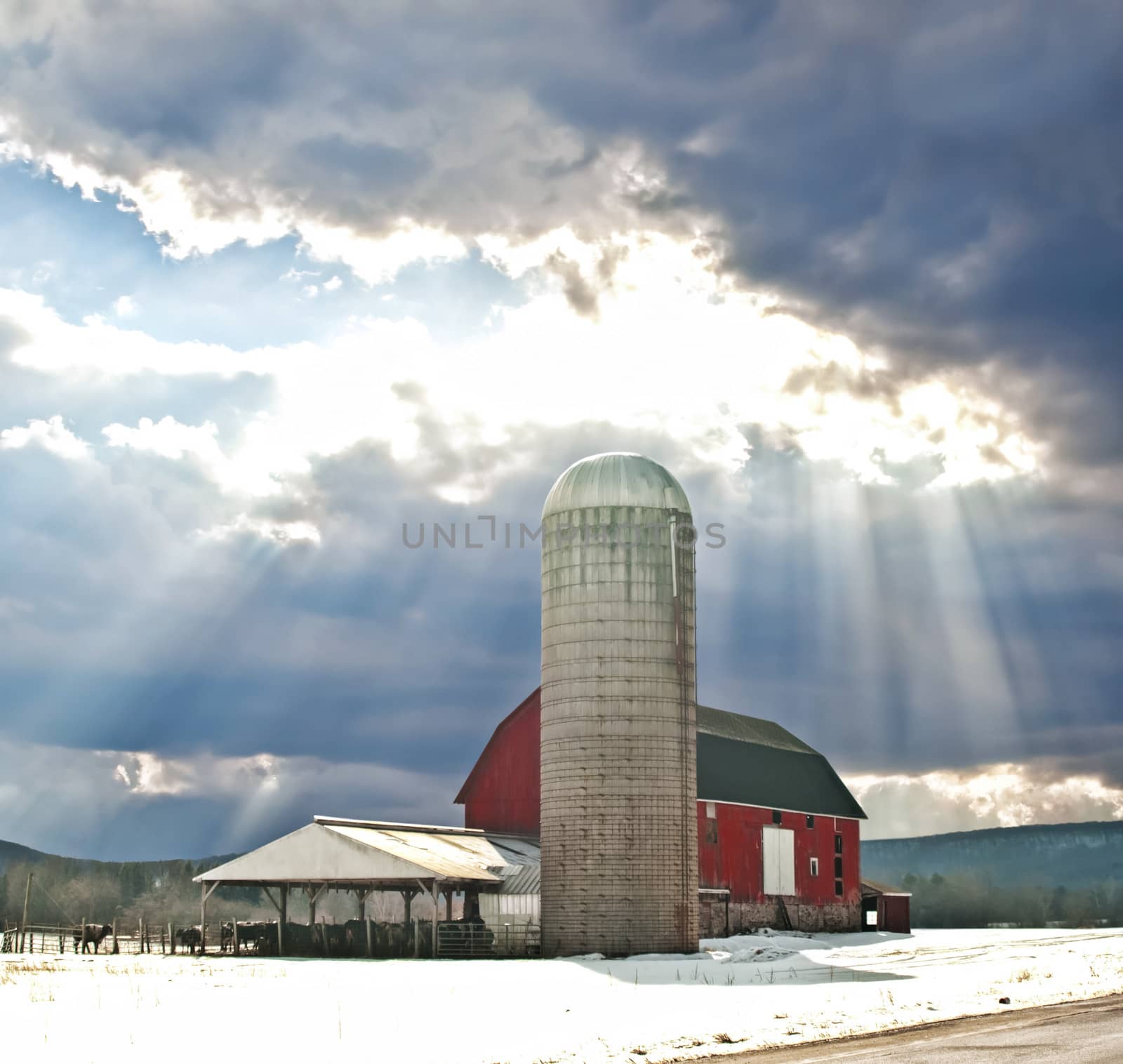 barn in winter with sunrays