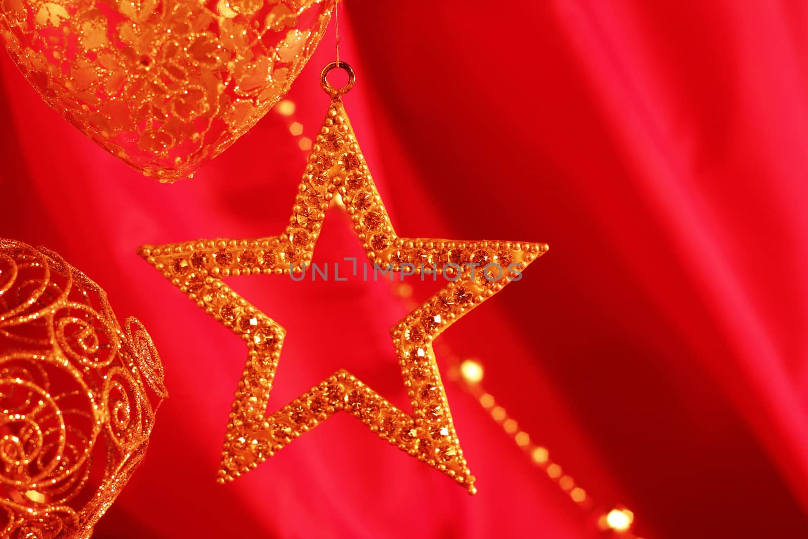 Golden christmas decoration on red fabric background