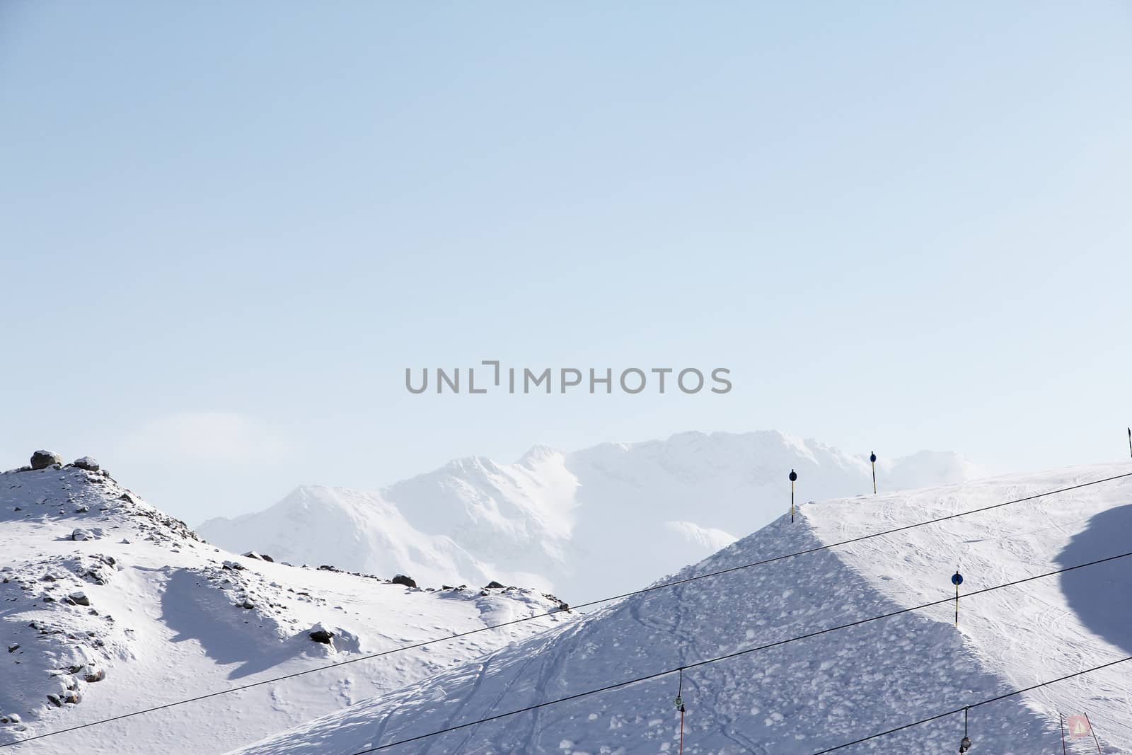 Mountain peaks of winter alps under blue sky