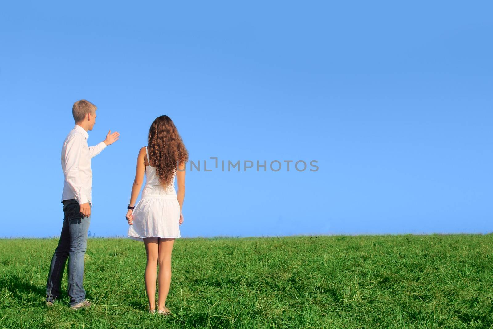 Young couple on field talking about their future