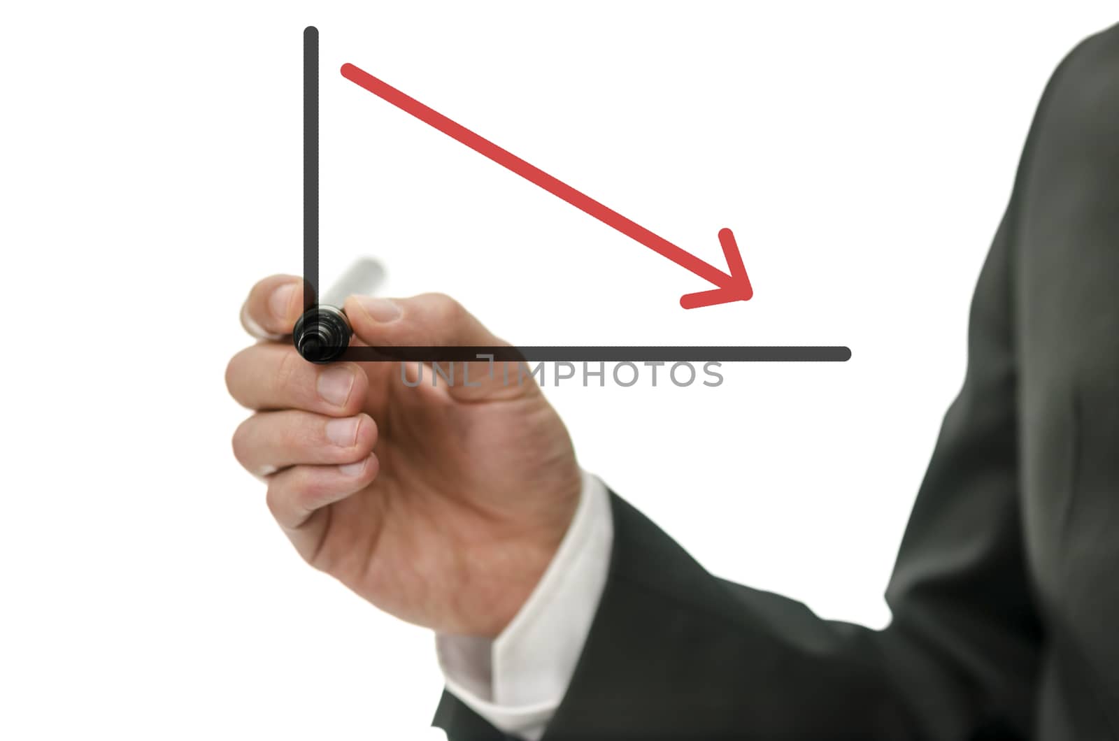 Business man drawing falling graph with red arrow.