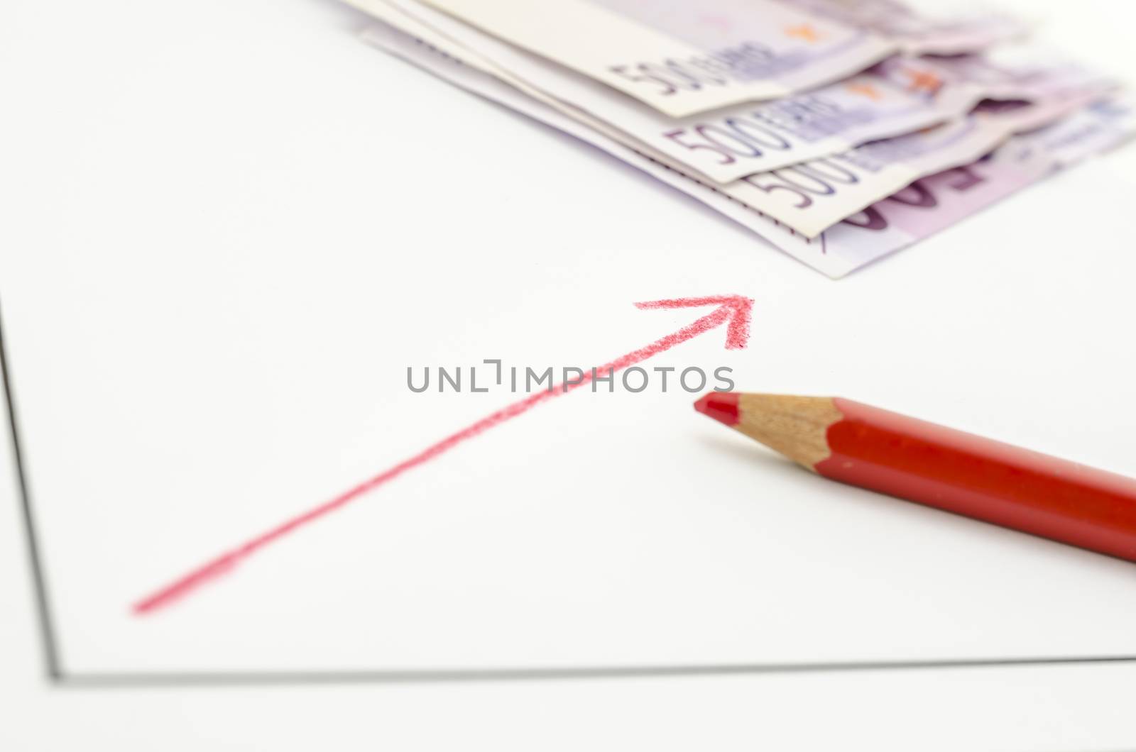 Growing financial graph with red arrow with Euro banknotes in background.