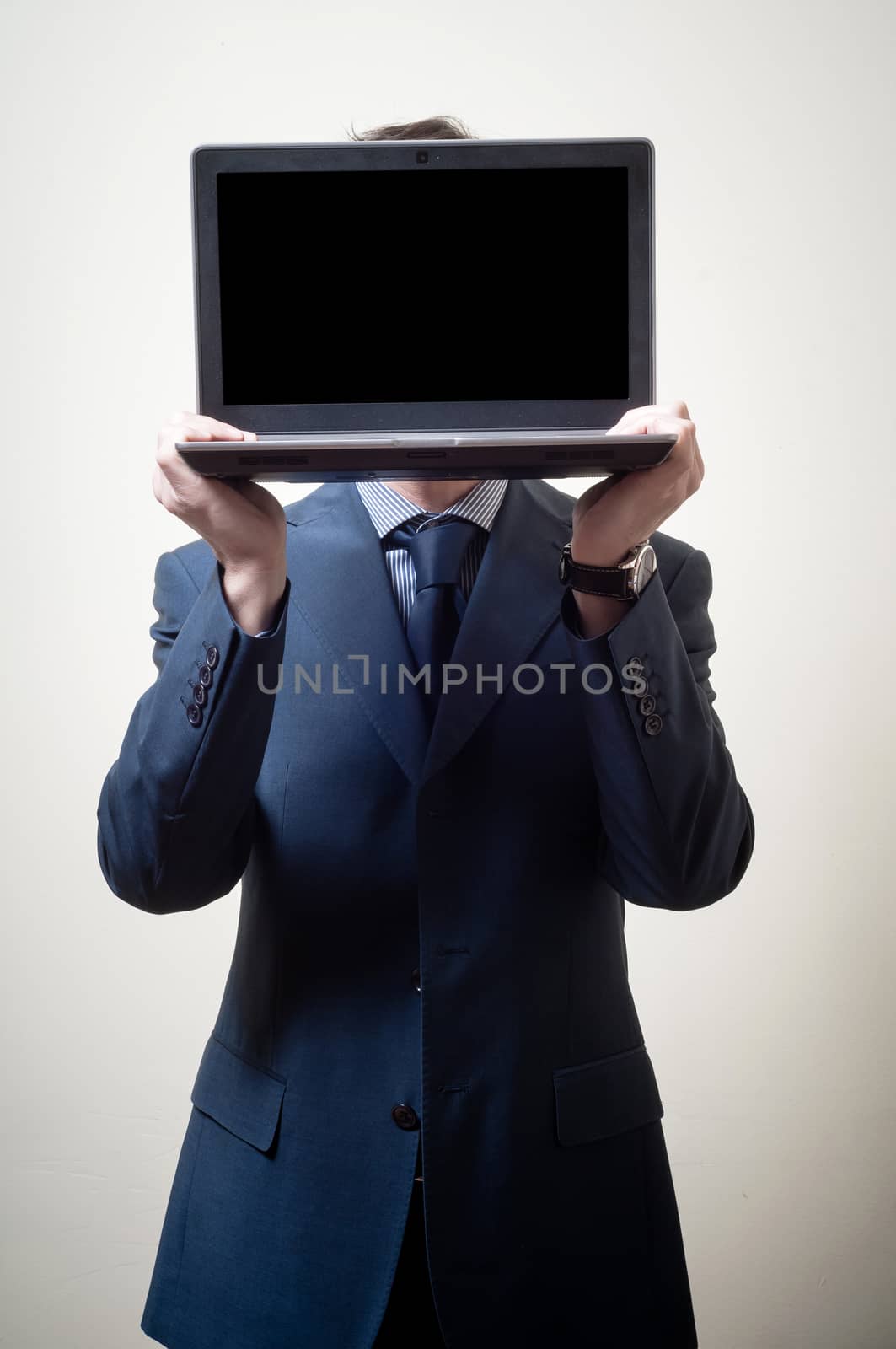 businessman with notebook in head on gray background