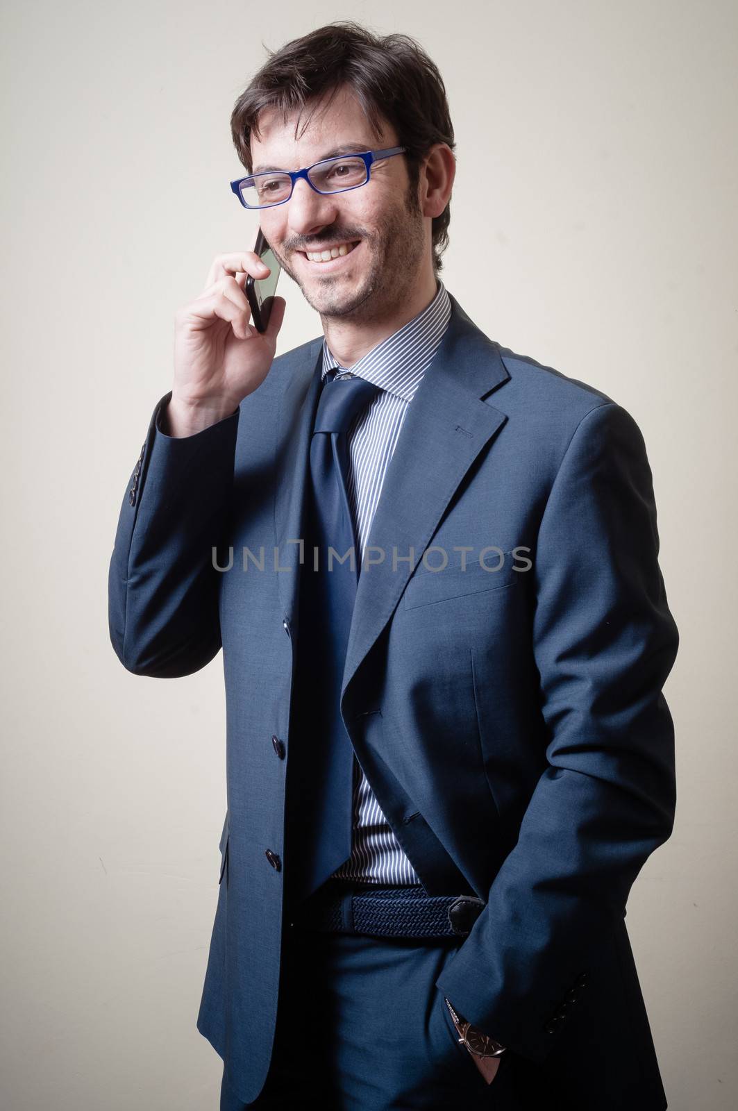 businessman on the phone on gray background