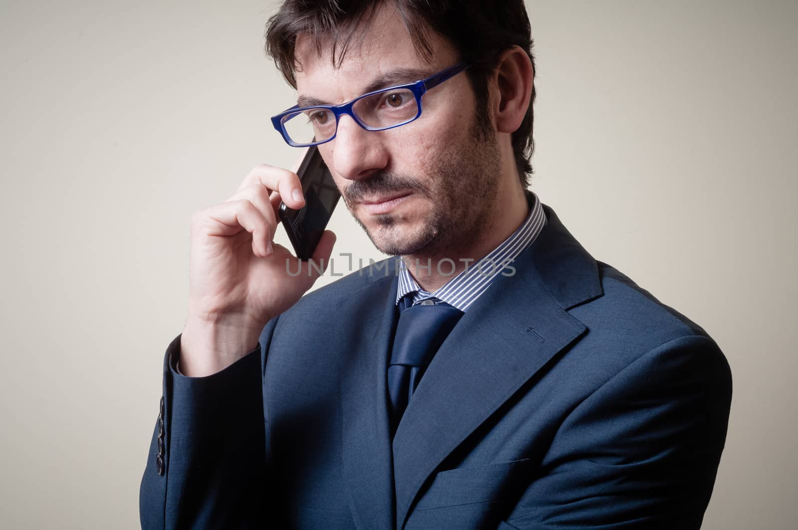 businessman on the phone on gray background