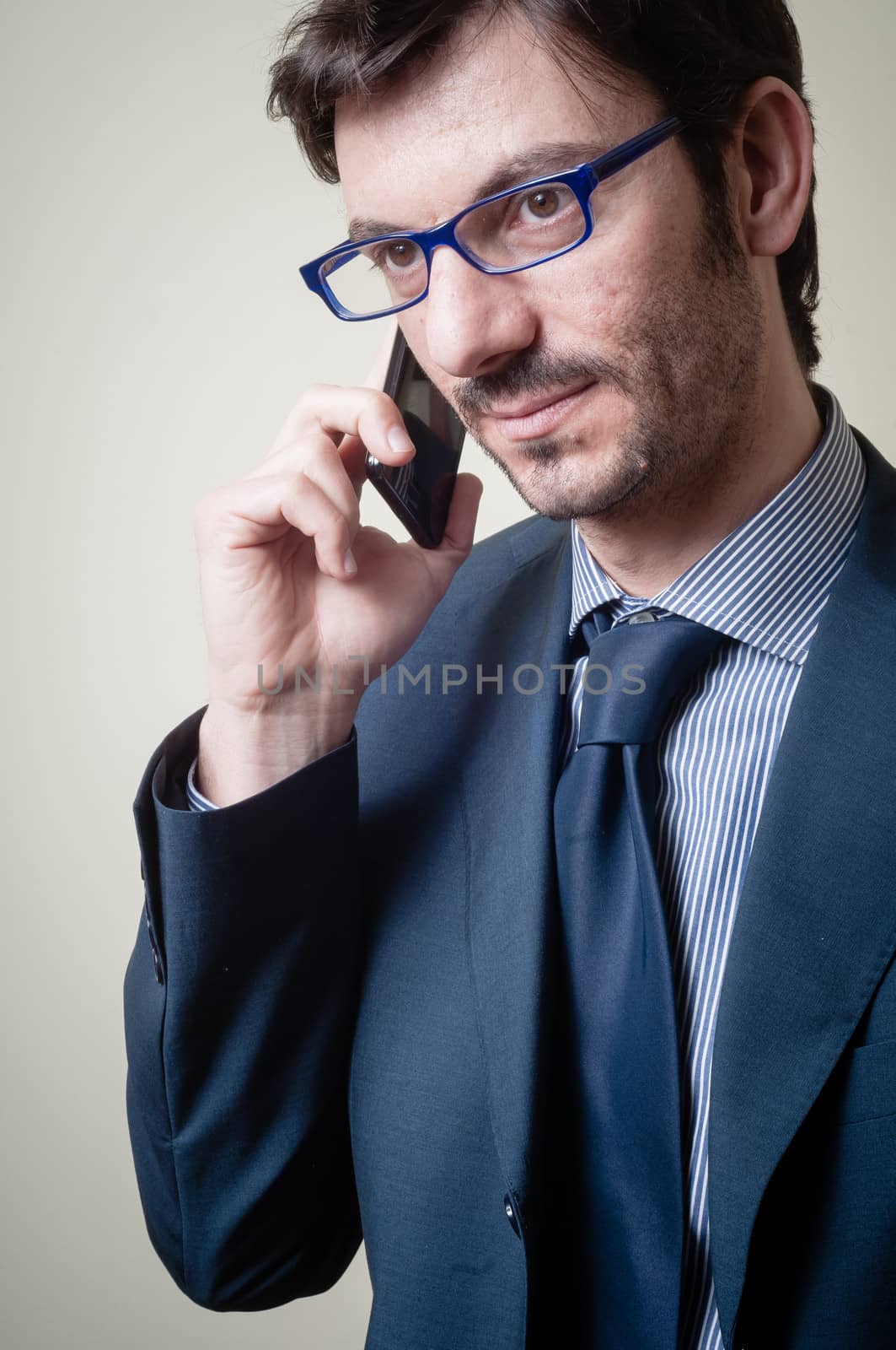 businessman on the phone on gray background