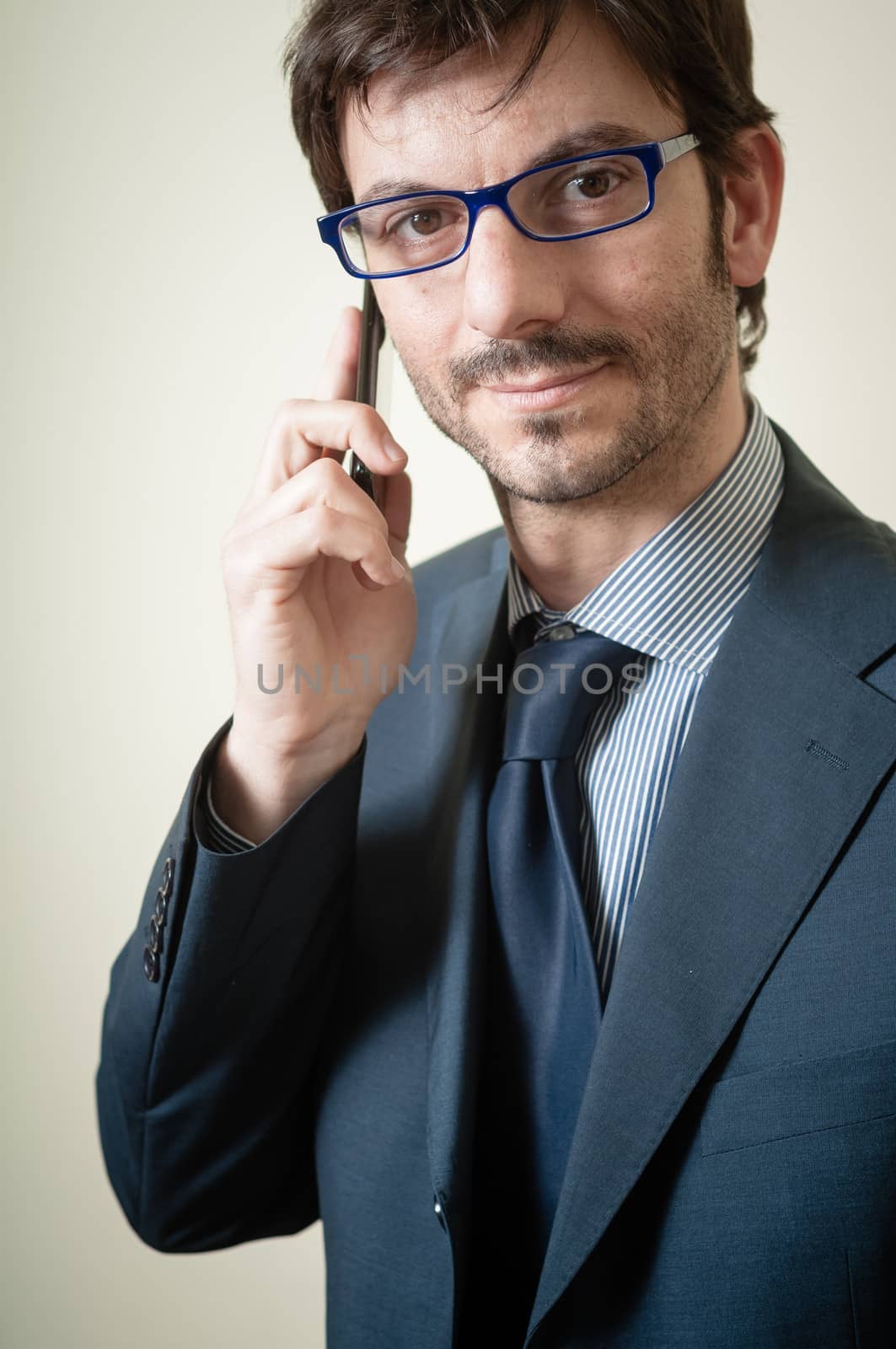 businessman on the phone on gray background