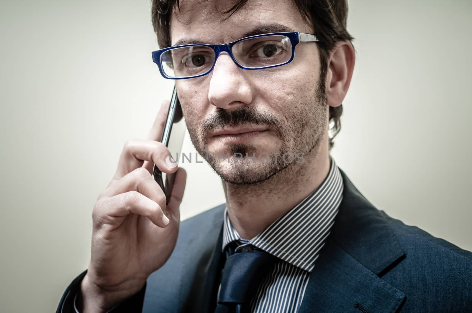 businessman on the phone on gray background