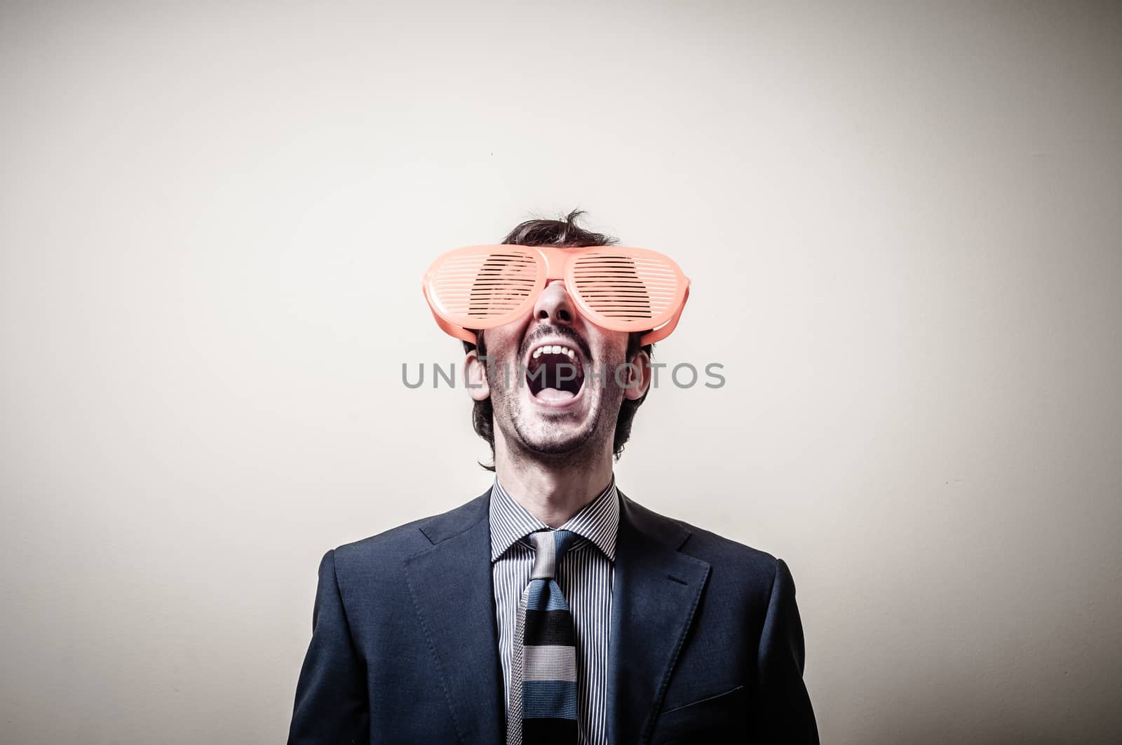 funny businessman with big orange glasses on gray background