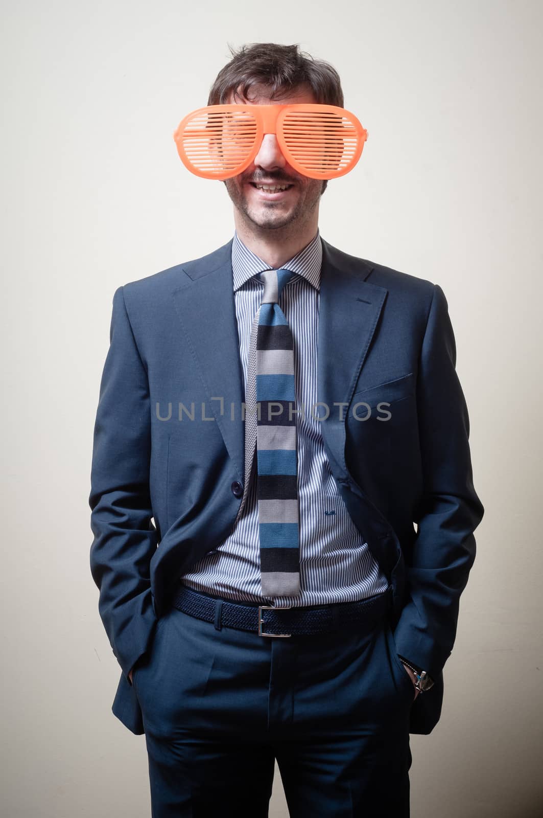 funny businessman with big orange glasses on gray background