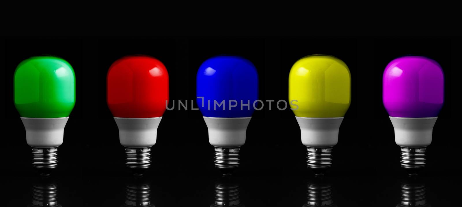 Colored light bulbs in row against black background