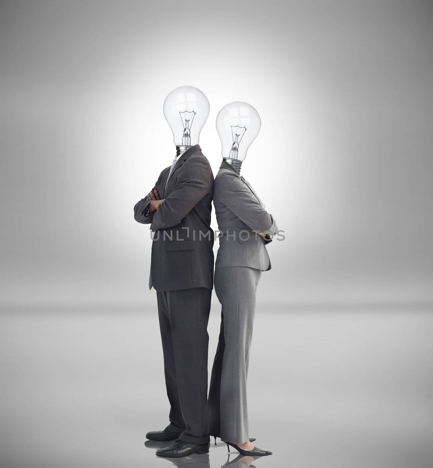 Business people with light bulbs instead of heads standing back to back