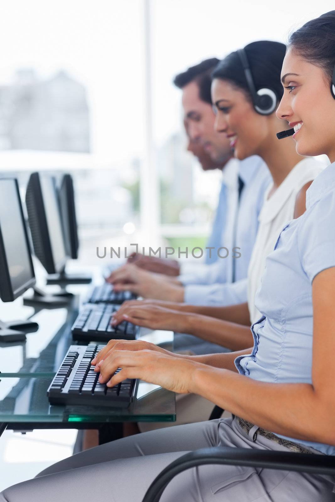 Cheerful team of call centre employees by Wavebreakmedia