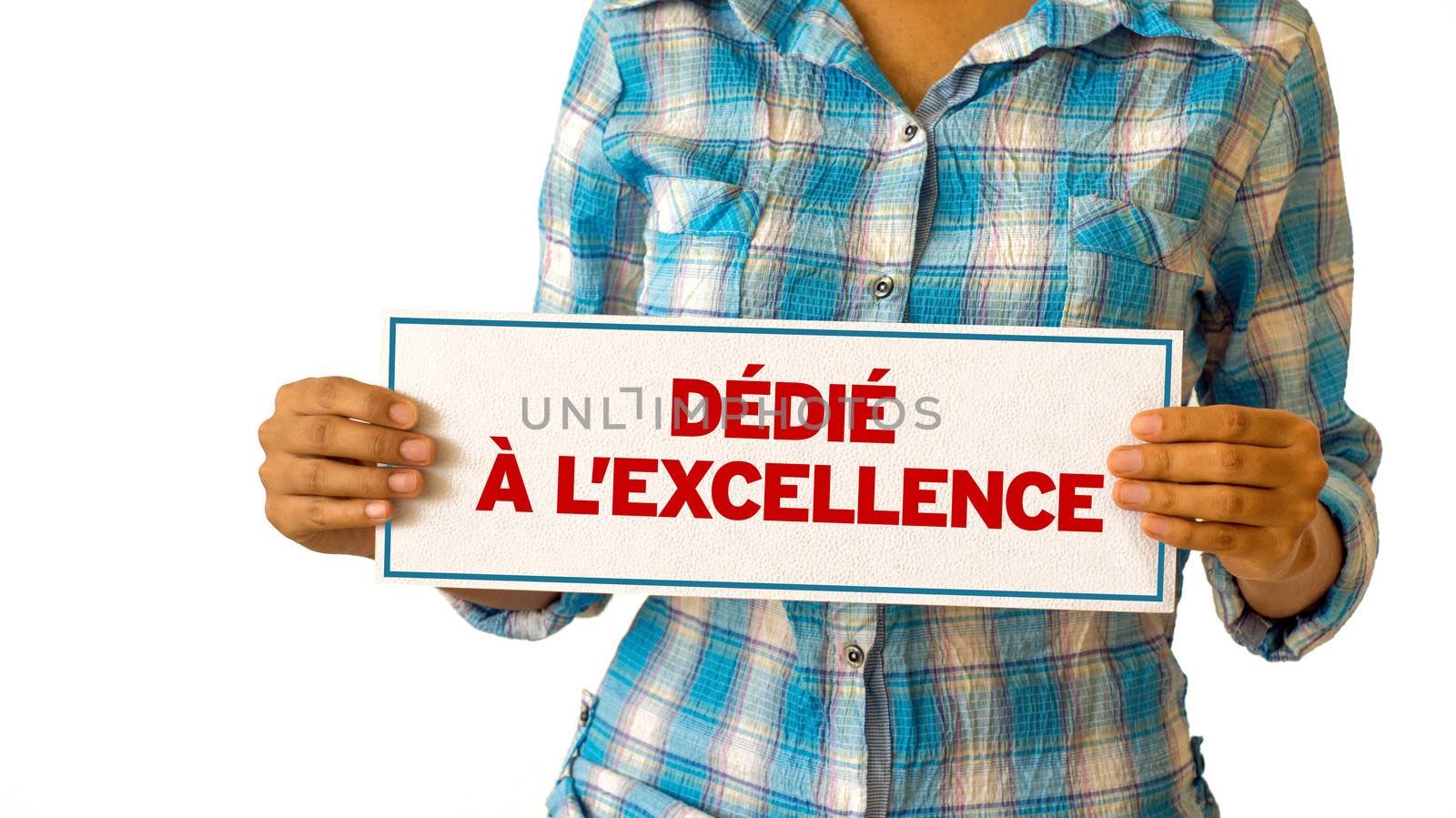 A woman holding a Dedicated To Excellence sign.